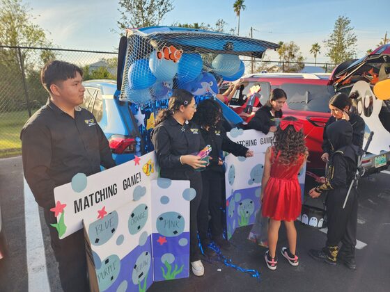 Students at a trunk-or-treat event